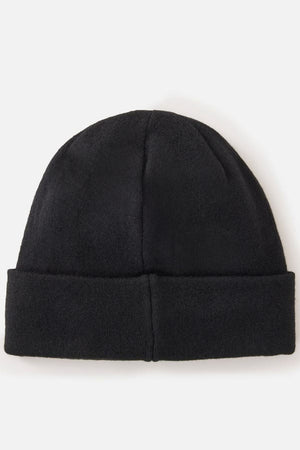 The Rip Curl Anti-Series Reg Tech Beanie, a plain black beanie with a folded brim, is perfect for outdoor adventures and shown against a white background.