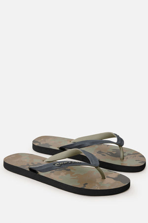 The Rip Curl Camo Bloom Thongs feature camouflage-patterned BLOOM algae foam soles with dark green and gray straps, providing comfort on a clean white background.