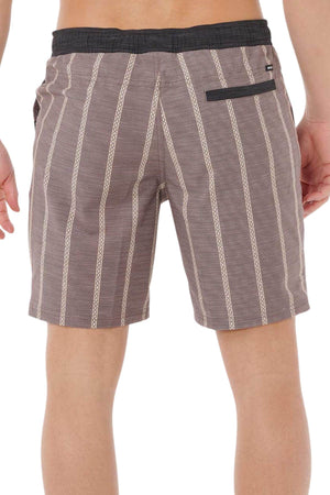 A person is shown from the back wearing Rip Curl Boardwalk Jackson Volley boardshorts in brown and beige vertical stripes, featuring an elastic waistband, single back pocket, and quick-dry fabric, set against a plain white background.