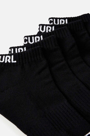 A close-up image showcases four pairs from the Rip Curl Brand Ankle Sock 5 Pack in black, each featuring white "CURL" text on the cuffs and offering arch support, set against a plain backdrop.