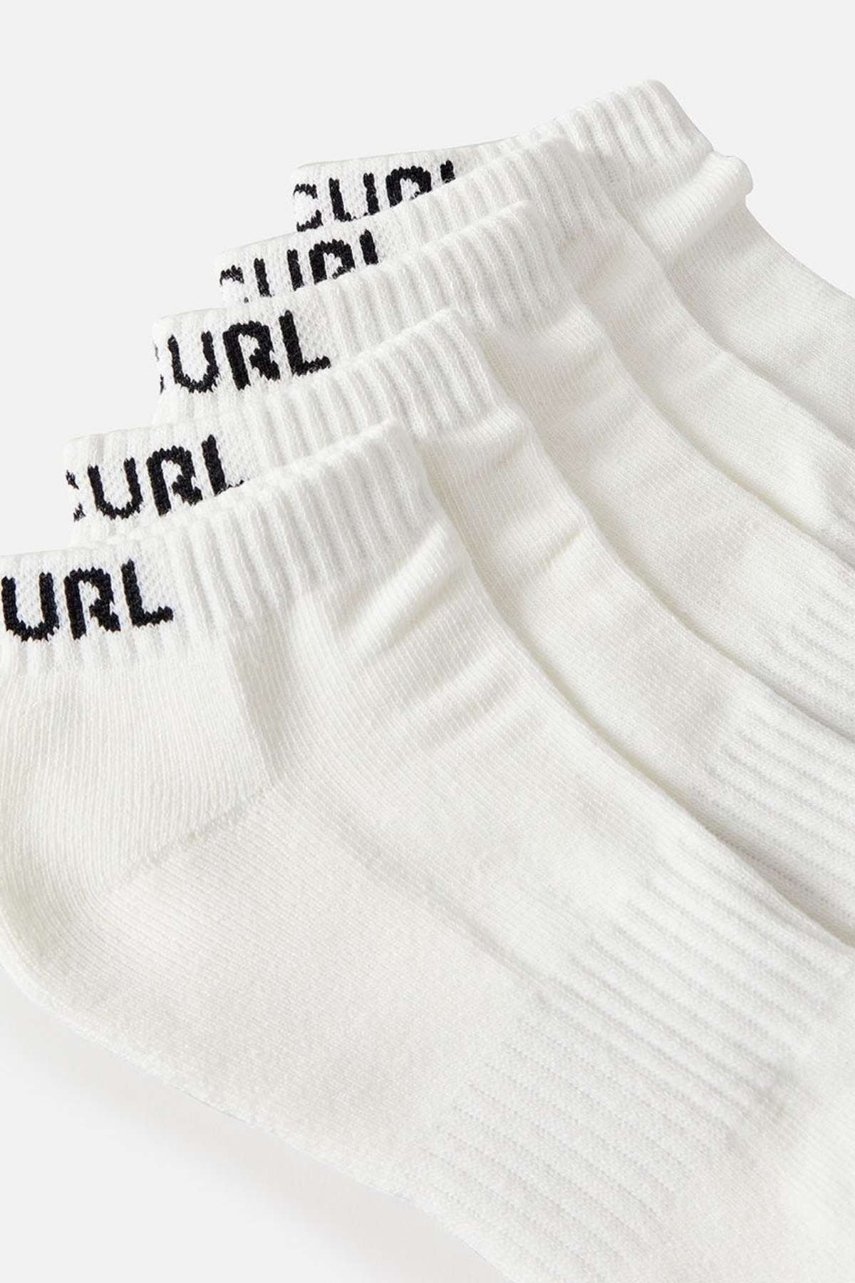 Close-up of three pairs of white ankle socks from the Rip Curl Brand Ankle Sock 5 Pack, showcasing ribbed cuffs and arch support. The socks are adorned with black text "URL" near the top and are neatly arranged, fanned out on a light gray background, combining both style and comfort in every pair.