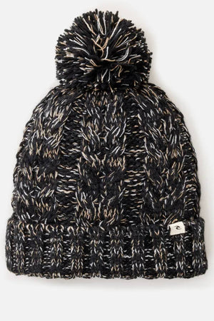 The Rip Curl Classic Regular Pom Pom Beanie is a black and white cable knit hat with a large top pom-pom, a folded brim, and a small rectangular front tag.