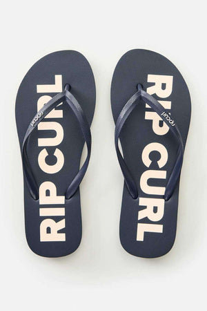 The Rip Curl Classic Surf Bloom Thongs feature ergonomic molded straps that complement a sleek black footbed adorned with "RIP CURL" in bold white letters. Made from BLOOM algae-blended foam, they offer a stylish and sustainable option for any plain backdrop.