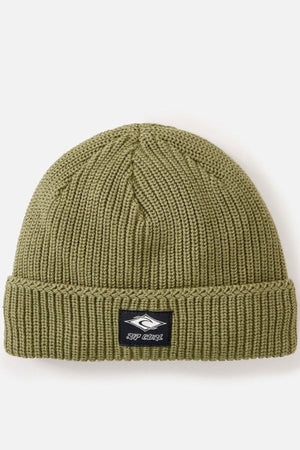The Rip Curl Classic Surf Lined Reg Beanie is a green ribbed knit cotton hat with a turned-up cuff and black patch logo, perfect for outdoor adventures. Shown against a plain white background.