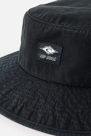 Close-up of the Rip Curl Classic Surf Mid Brim Hat in black cotton, featuring the iconic Rip Curl logo with its signature wave design and text. Ideal for outdoor adventures, this hat displays a subtle textured pattern concentrated on the upper section.