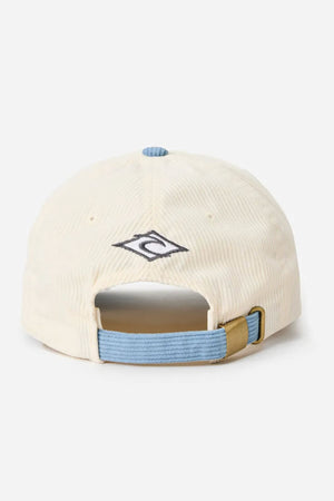 The Rip Curl Diamond 2.0 Adj Cap is a cream-colored, low-profile hat shown from the back, featuring a blue adjustable strap with brass buckle and an embroidered logo above the opening.