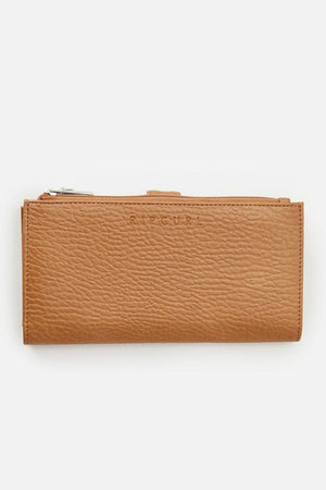 The Rip Curl Essentials II Phone Wallet is crafted from tan leather with a textured surface and features a visible zipper at the top. It is adorned with an embossed subtle Rip Curl logo on the front and includes a handy mobile phone pocket, all showcased against a plain white background.