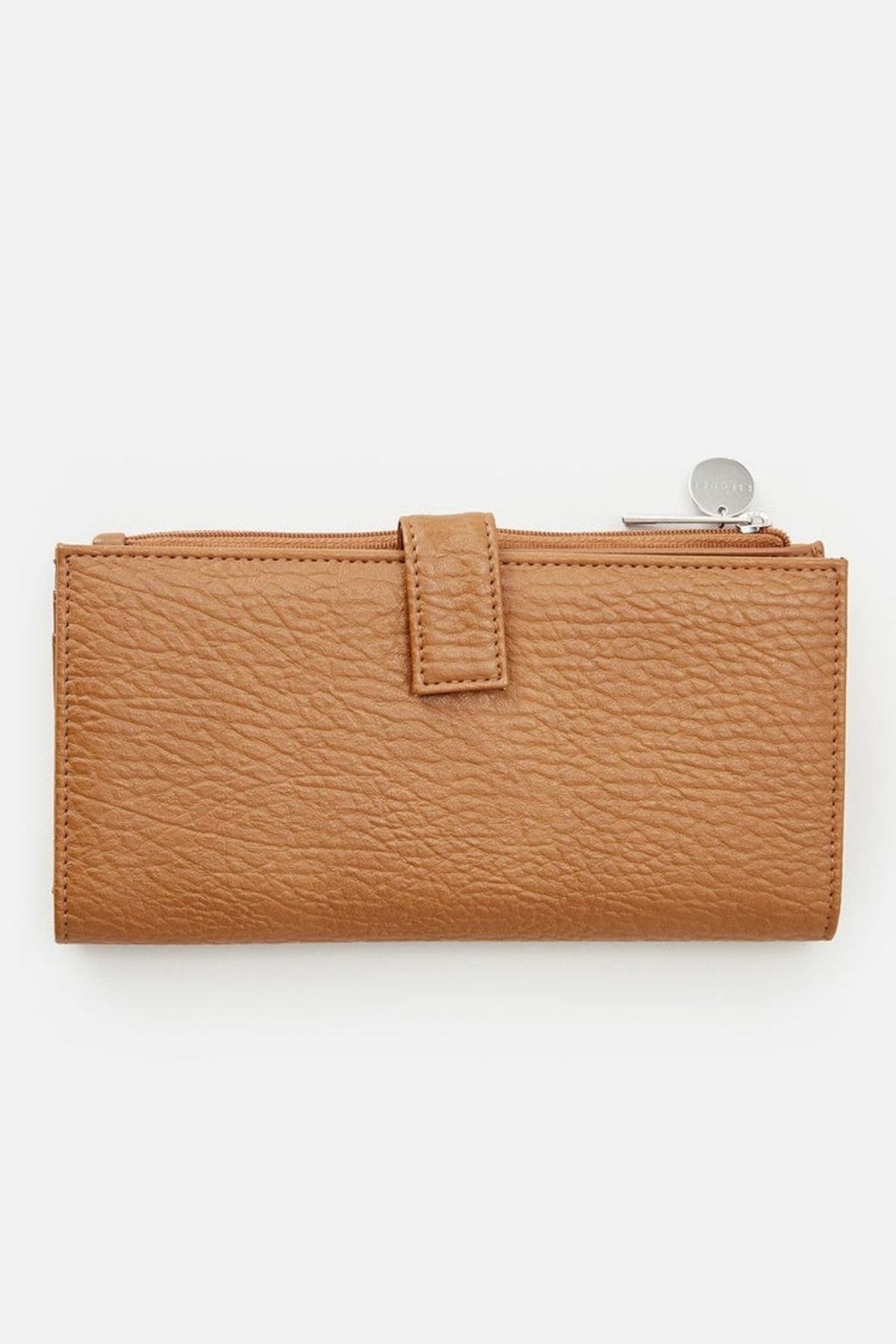 The Rip Curl Essentials II Phone Wallet is a brown leather accessory with a textured finish, featuring both a top zipper and a front snap closure. This stylish piece mimics classic Rip Curl designs and includes a silver round zipper pull for added elegance. Perfect for those looking for both style and practicality, it is showcased on a plain white background.