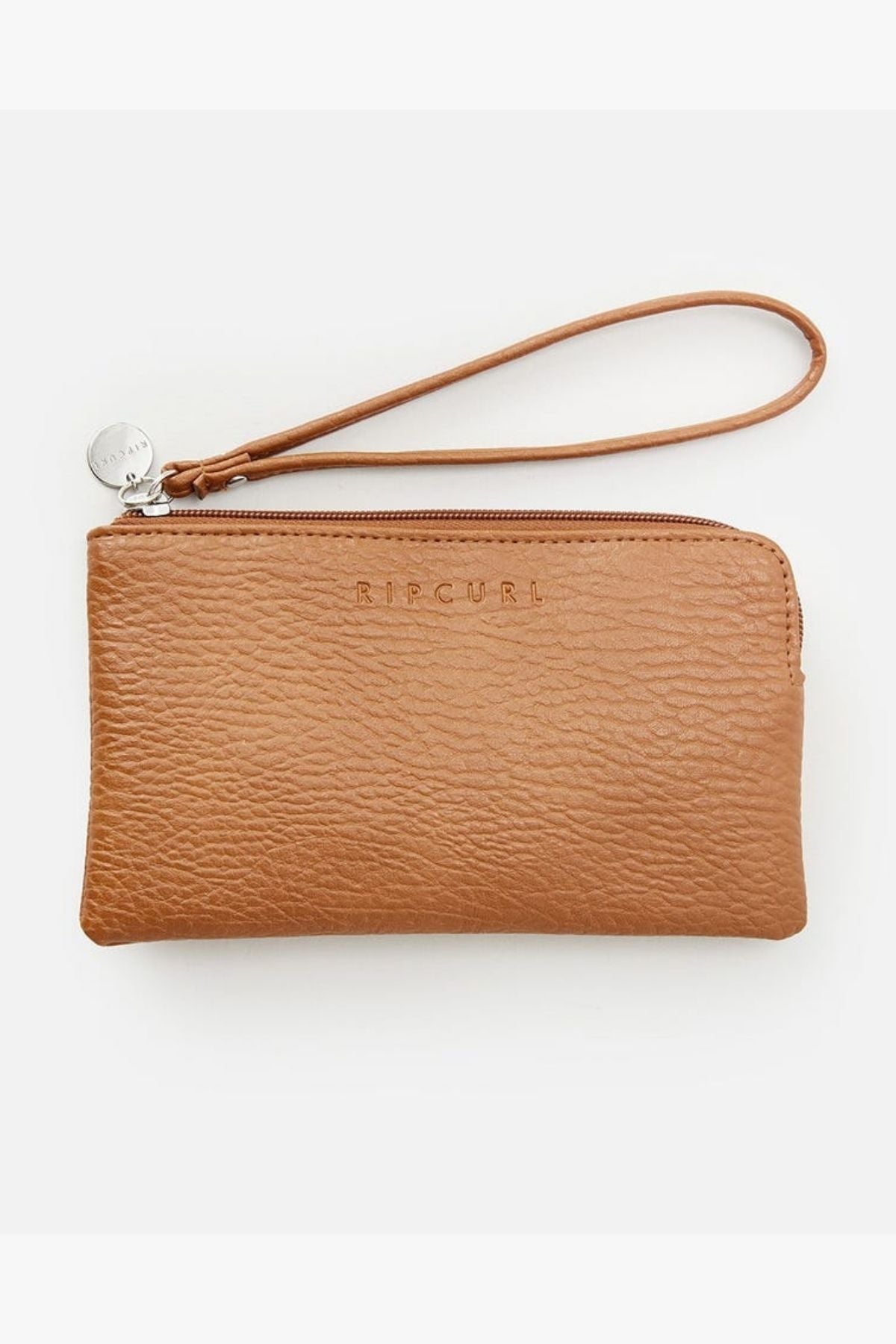 The Rip Curl Essentials 2 Wristlet, made from a luxurious brown faux-leather, is embellished with a delicate embossed logo. It includes a top zipper closure and a wrist strap highlighted by a petite round silver charm, all presented against a simple light backdrop.