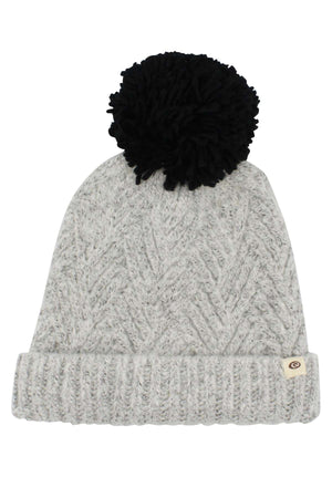 The Rip Curl Groundswell Pom Pom Beanie is a light gray knit beanie with a folded brim and a large black pom-pom on top, featuring a small circular logo tag on the brim.
