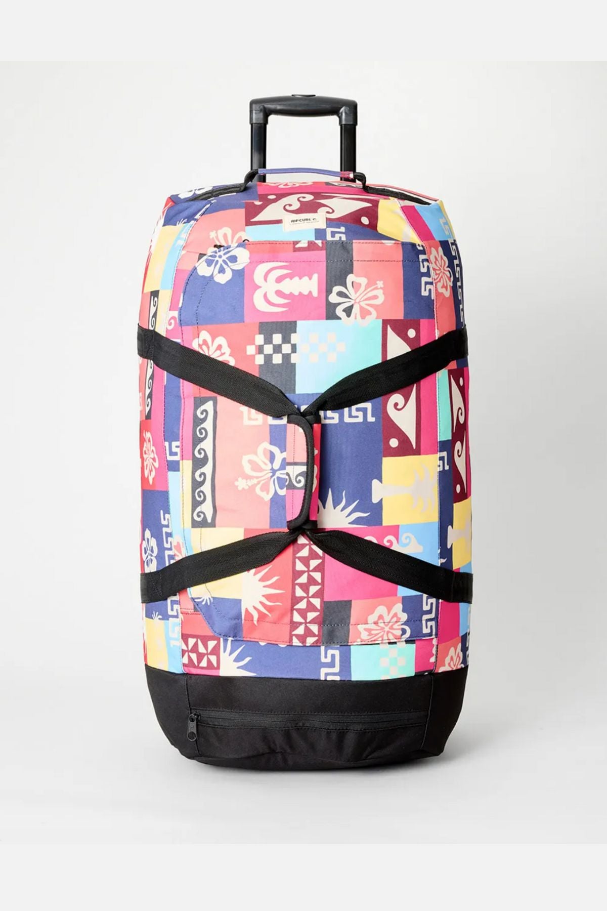 The Rip Curl Jupiter 80L Mixed Travel Bag features a vibrant patchwork of abstract shapes, black straps and base, and is crafted from recycled polyester—perfect luggage for stylish journeys.