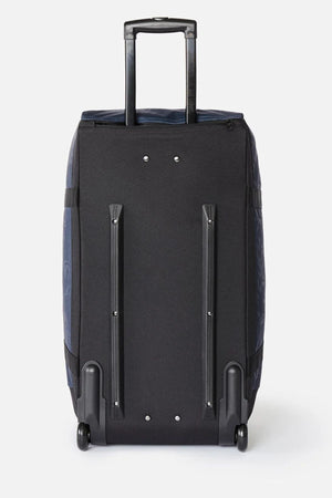 Back view of a Rip Curl Jupiter Archive 80L rolling duffel bag, featuring a retractable handle and two wheels at the base.