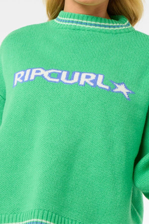 Someone wears the Rip Curl Las Dalias Sweater, a cozy, bright green knit featuring "RIP CURL" and a star logo in white and purple across the chest.