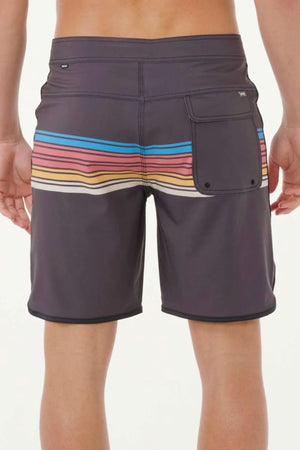 A person shown from behind wears Rip Curl Mirage Surf Revival 19" Boardshorts in dark gray with horizontal multicolored stripes and a back pocket, made from quick-drying recycled PET fabric, against a plain background.