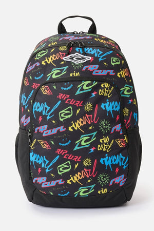 Black Rip Curl Ozone Boy 30L backpack with a multicolored graffiti-style pattern featuring text, lightning bolts, and sun icons.