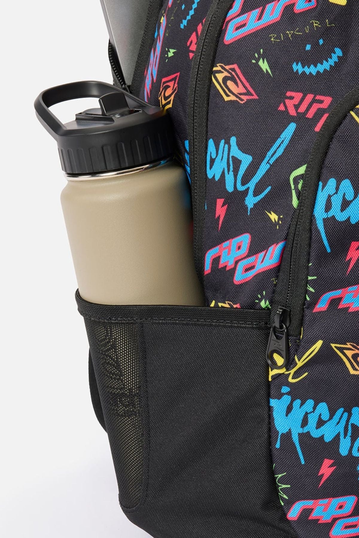 A black Rip Curl Ozone Boy 30L Backpack with a colorful, graffiti-style print in a side mesh pocket holding a tan water bottle.