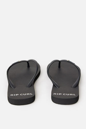 A pair of Rip Curl Premium Surf Bloom Thongs with the words "RIP CURL" printed in white on the footbeds. These black flip-flops feature a simple design with black straps and rest on a plain white background.
