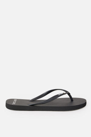 A single black Rip Curl Premium Surf Bloom Thong with a simple design. The footbed is flat and made of a smooth material, while the strap is thin and also black. The brand name "Rip Curl" is visible in white letters on the strap and near the heel of the footbed. The background is white.