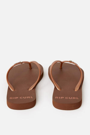 A pair of Rip Curl Premium Surf Bloom Thongs with brown straps are displayed against a plain white background. The brand name "RIP CURL" is printed in white on the footbeds near the heel.