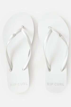 A pair of Rip Curl Premium Surf Bloom Thongs in white with silver straps, viewed from above on a white background. The Rip Curl logo appears on the footbeds and strap—ideal stylish, relaxed footwear for the beach.
