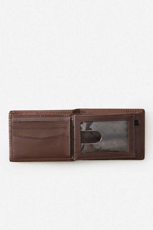The Rip Curl Raw Energy RFID Slim Wallet in brown buff cow leather shows multiple card slots on the left and a transparent ID window on the right, set against a light gray background.