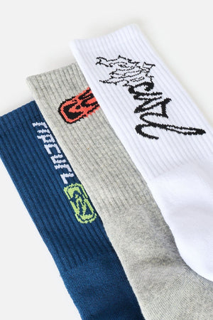 Three pairs from the Rip Curl Retro Crew Sock 3 Pack in blue, grey, and white, each featuring distinct text and graphic designs near the cuffs in various colors. These ribbed, cushioned socks are displayed overlapping on a light background, highlighting their comfort and stylish appeal.