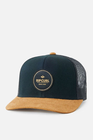 The Rip Curl Routine Curve Trucker cap features a stylish black and brown design with a mesh back, making it ideal for outdoor activities. It showcases a round logo patch on the front that reads "Rip Curl Since 1969," and includes a flat brown brim that enhances its casual appeal.