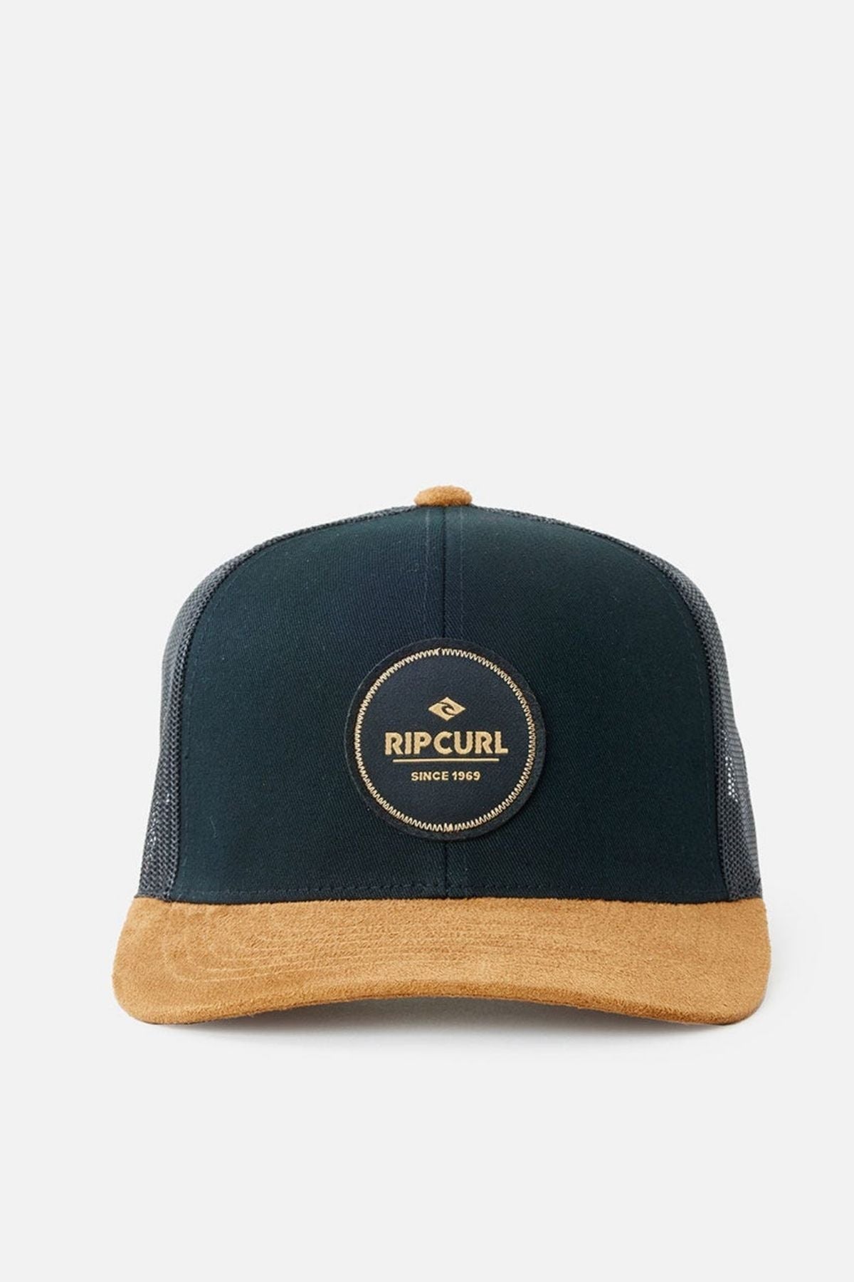 The Rip Curl Routine Curve Trucker cap showcases a "Rip Curl Since 1969" logo patch, with a black front panel and a tan suede brim. Ideal for outdoor activities, it features mesh sides and back for breathability, complemented by herringbone spandex for added style.