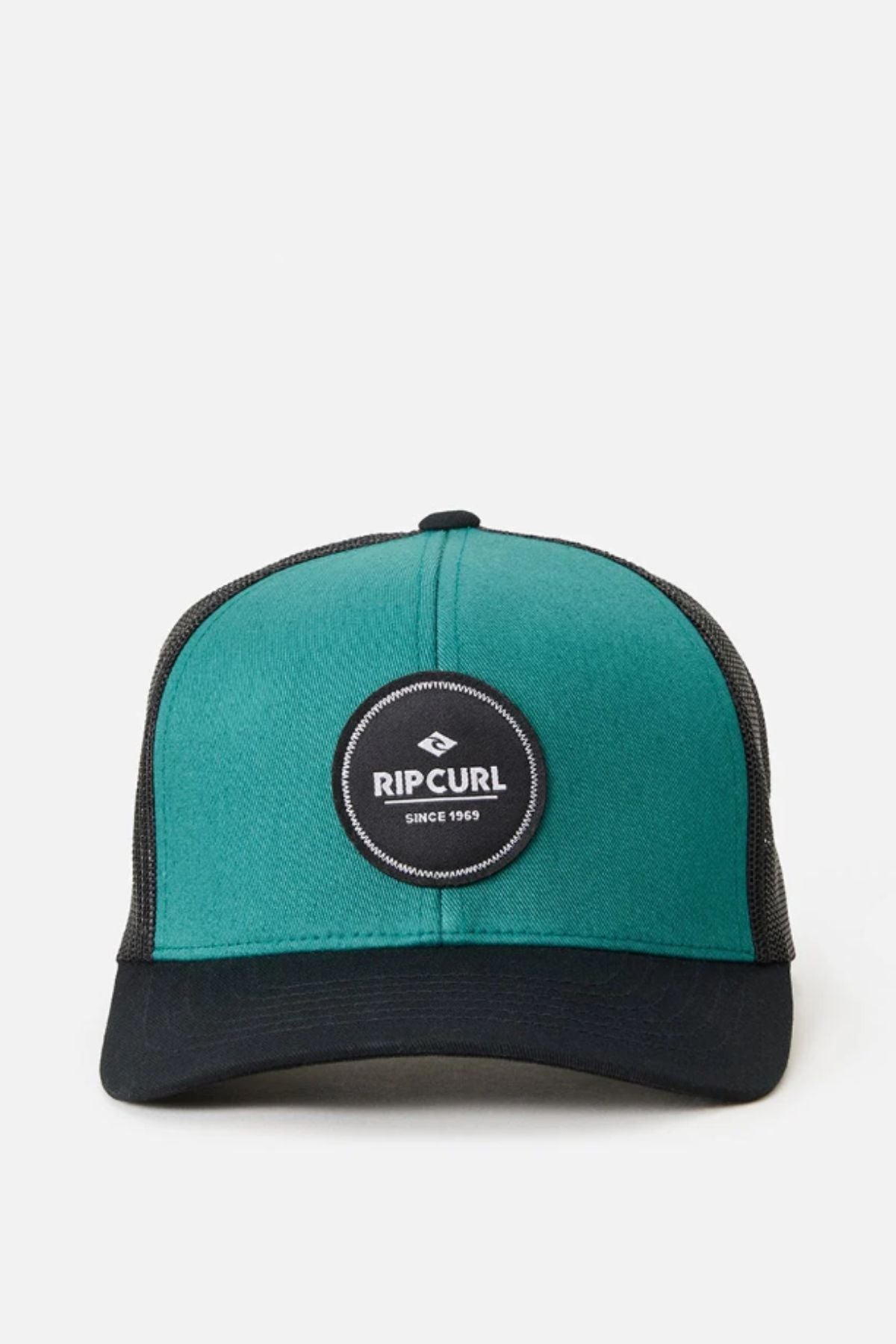 A green and black Rip Curl Routine Curve Trucker hat featuring a black circular “Rip Curl” logo patch, white “RIP CURL SINCE 1969” text, cotton twill front, mesh back, and a solid black bill.