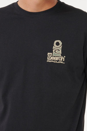A person wearing a black Rip Curl Vaporcool Search Stack Tee featuring a beige "Search Ripcurl" graphic on the left chest, designed for quick drying and superior moisture control.
