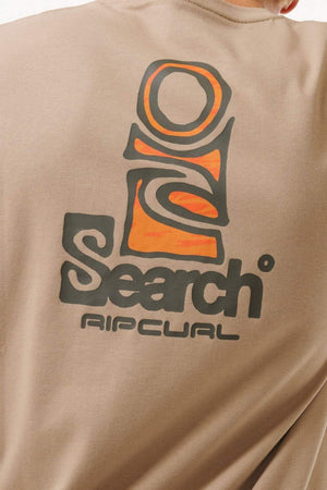 A close-up of the Rip Curl Vaporcool Search Stack Tee in tan, showcasing an abstract orange and black logo above "Search" and bold "Rip Curl," made with quick dry technology for ultimate comfort.