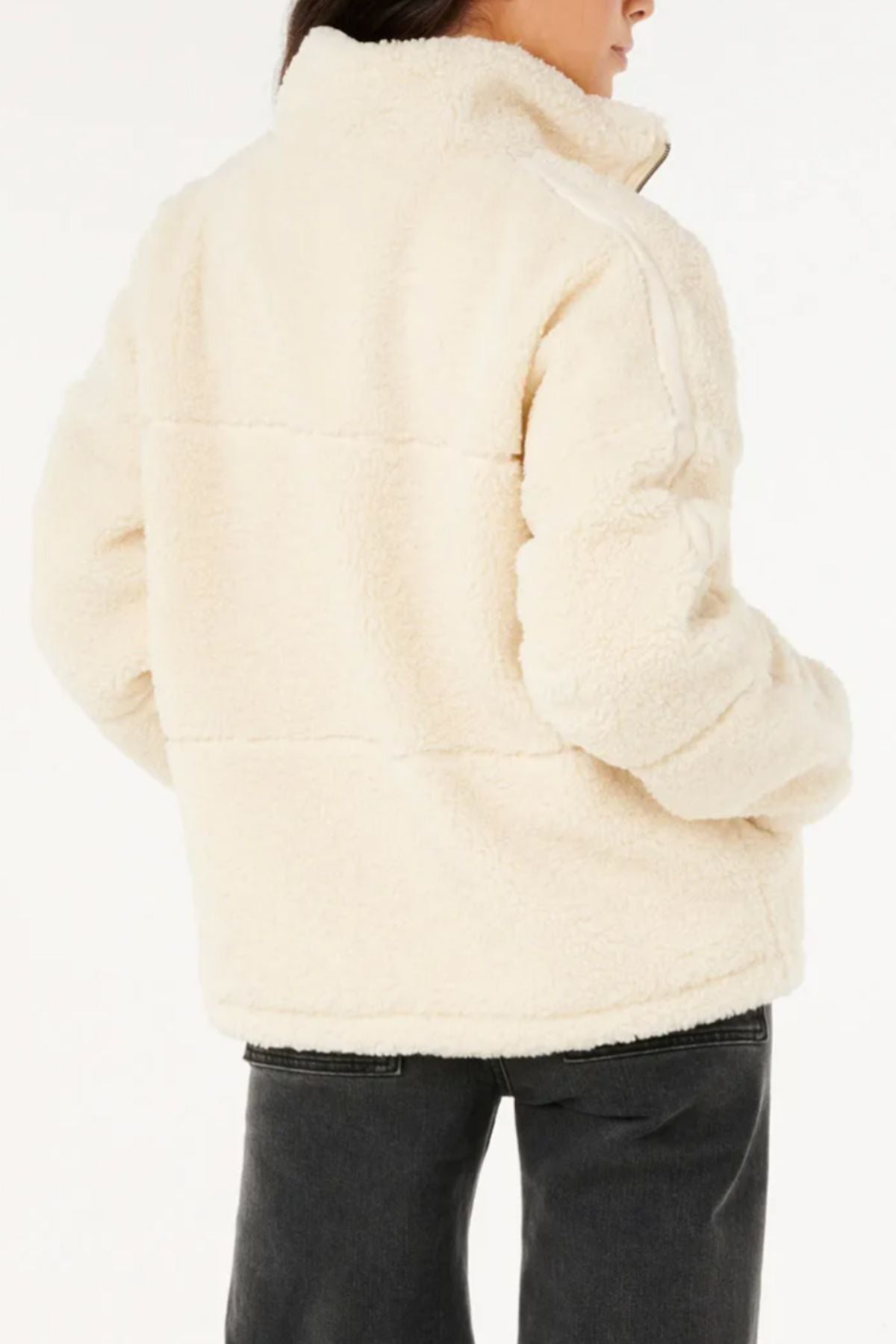 A person with dark hair and dark pants is shown from the back wearing the Rip Curl Cala Nights Sherpa Jacket with a high collar, made from recycled polyester sherpa, against a plain white background—ideal for cozy winter style.