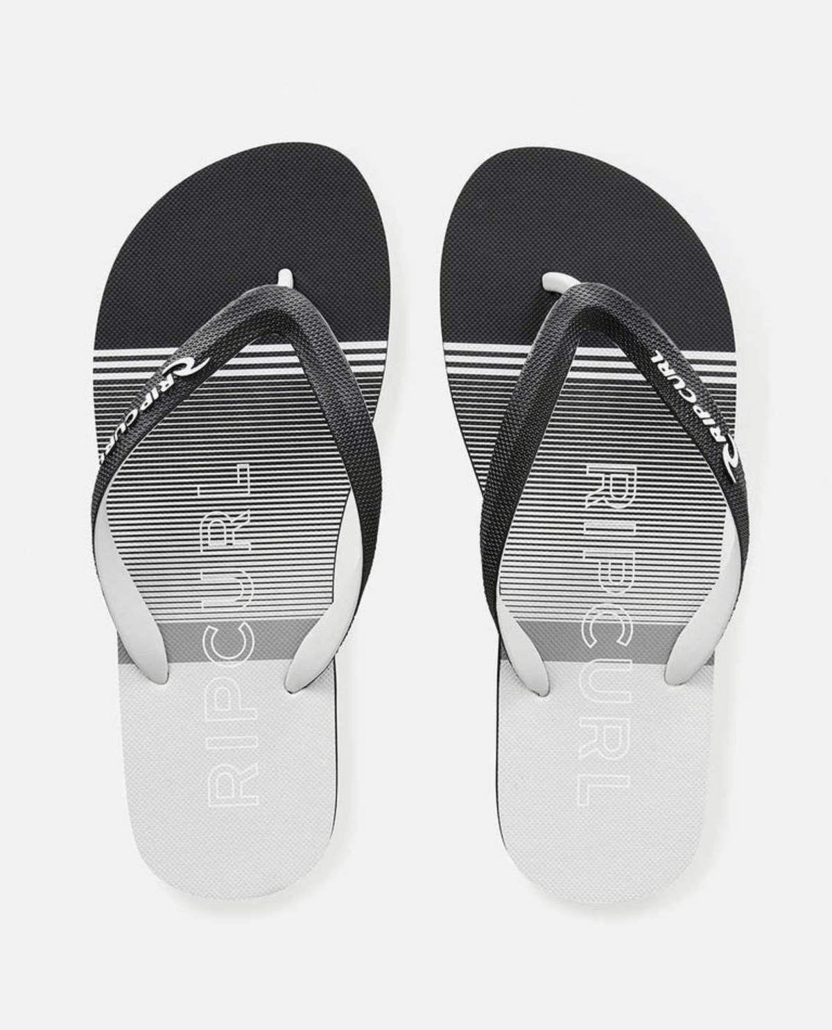 The Rip Curl Breakers Bloom Thongs feature horizontal stripes in sleek black and gray. With a simple thong strap and BLOOM algae-blended foam soles, they combine style with eco-friendly fashion.
