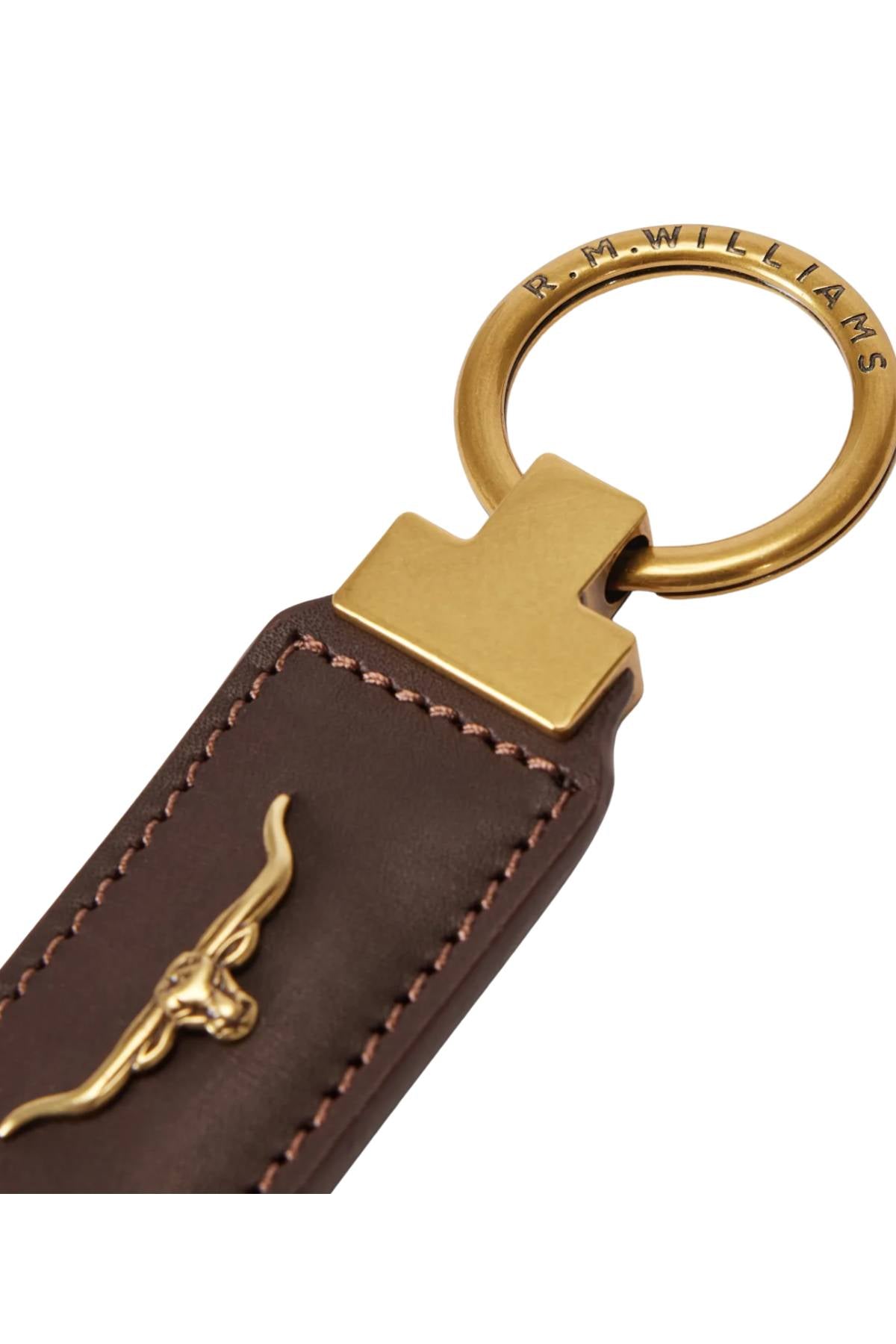 Close-up of the RM Williams Angaston Key Ring, featuring smooth leather, a brass ring engraved with "R.M.Williams," and a small gold longhorn logo attached.