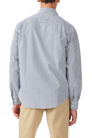 A person is shown from the back wearing an untucked RM Williams Augusta Classic Poplin Shirt in blue and white check with Longhorn embroidery, paired with beige pants. The long-sleeve button-up adds a relaxed yet refined touch as their arms rest at their sides.