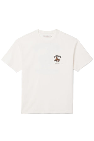 RM Williams Cloudbuster T-Shirt: White short-sleeve tee in soft organic cotton jersey with a small Cloudbuster motif and brown and black text on the left chest, shown laid flat on a white background.