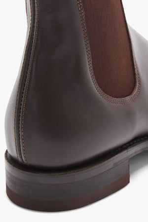 Close-up of the RM Williams Dynamic Flex Craftsman Bootβs back and side, showcasing yearling leather, detailed stitching, an elastic side panel, and a stacked wooden heel.