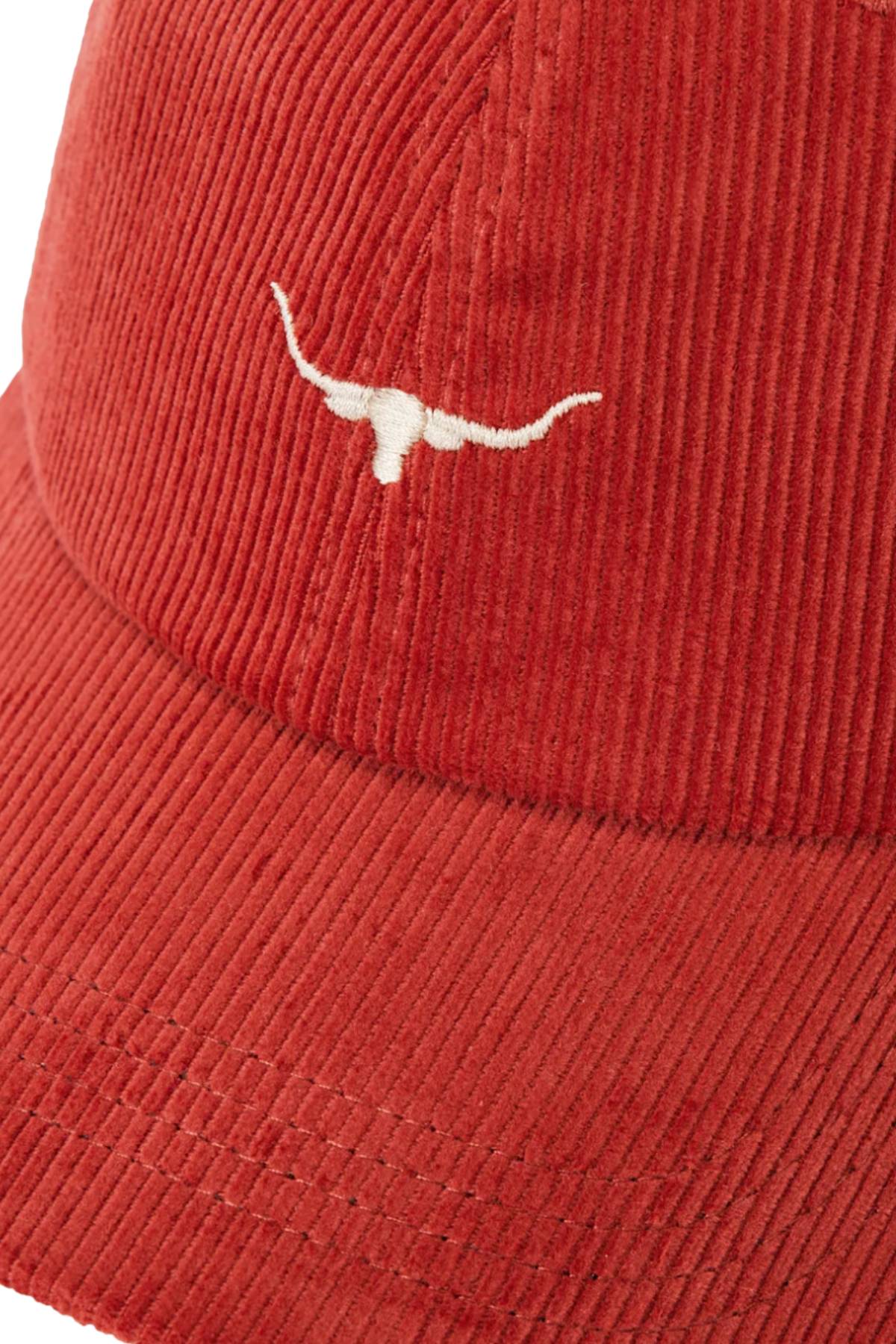Close-up of the RM Williams Mini Longhorn Cord Cap in red organic cotton corduroy, featuring a white embroidered Longhorn logo on the front and an adjustable strap for comfort.