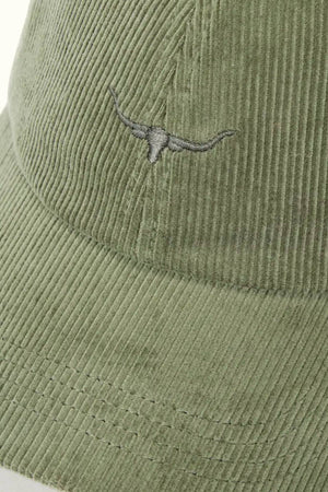 A close-up of the RM Williams Mini Longhorn Cord Cap in light green organic cotton corduroy, featuring an embroidered mini Longhorn logo on the front and an adjustable strap at the back.