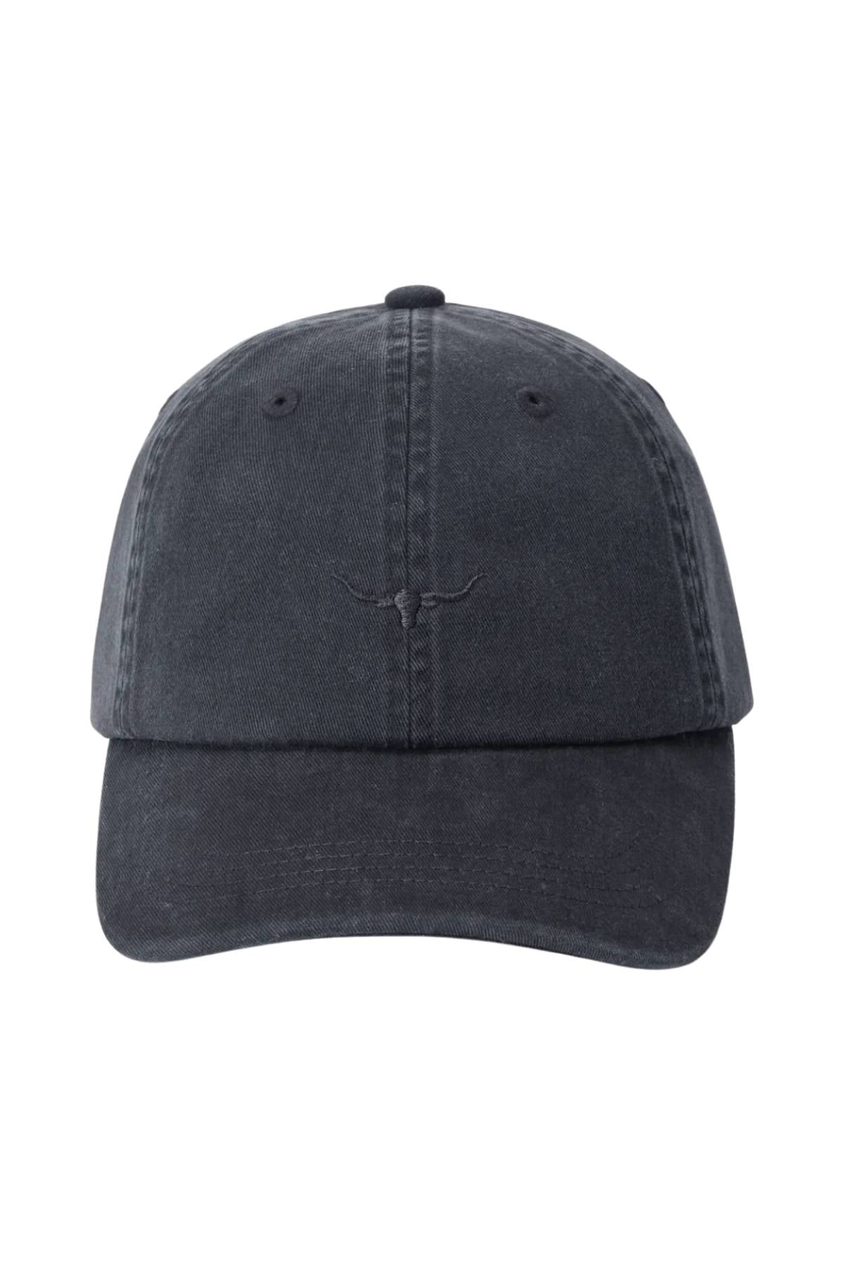 The RM Williams Mini Longhorn Twill Cap is a black, organic cotton baseball cap with visible stitching, a smile-like curved line on the front, an adjustable strap, and a slightly worn, faded look.