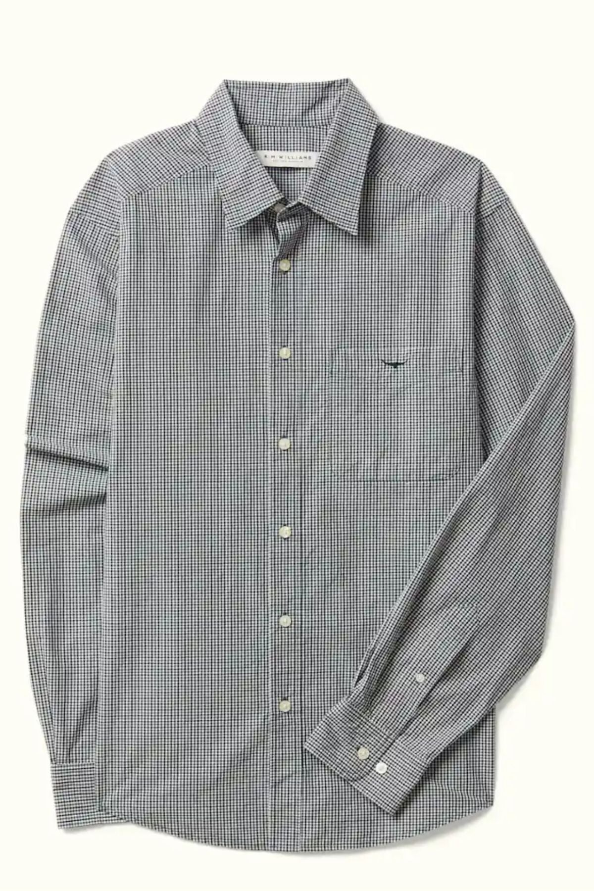The RM Williams Quinn Classic Poplin Shirt features a relaxed fit, black-and-white yarn-dyed check pattern, chest pocket, white buttons, and long sleeves. Shown laid flat on a light background.