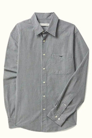 The RM Williams Quinn Classic Poplin Shirt features a relaxed fit, black-and-white yarn-dyed check pattern, chest pocket, white buttons, and long sleeves. Shown laid flat on a light background.
