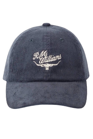 The RM Williams Script Longhorn Cord Cap is a dark blue organic cotton corduroy cap with an embroidered "R.M. Williams" logo and longhorn on the front, plus an adjustable strap for fit.