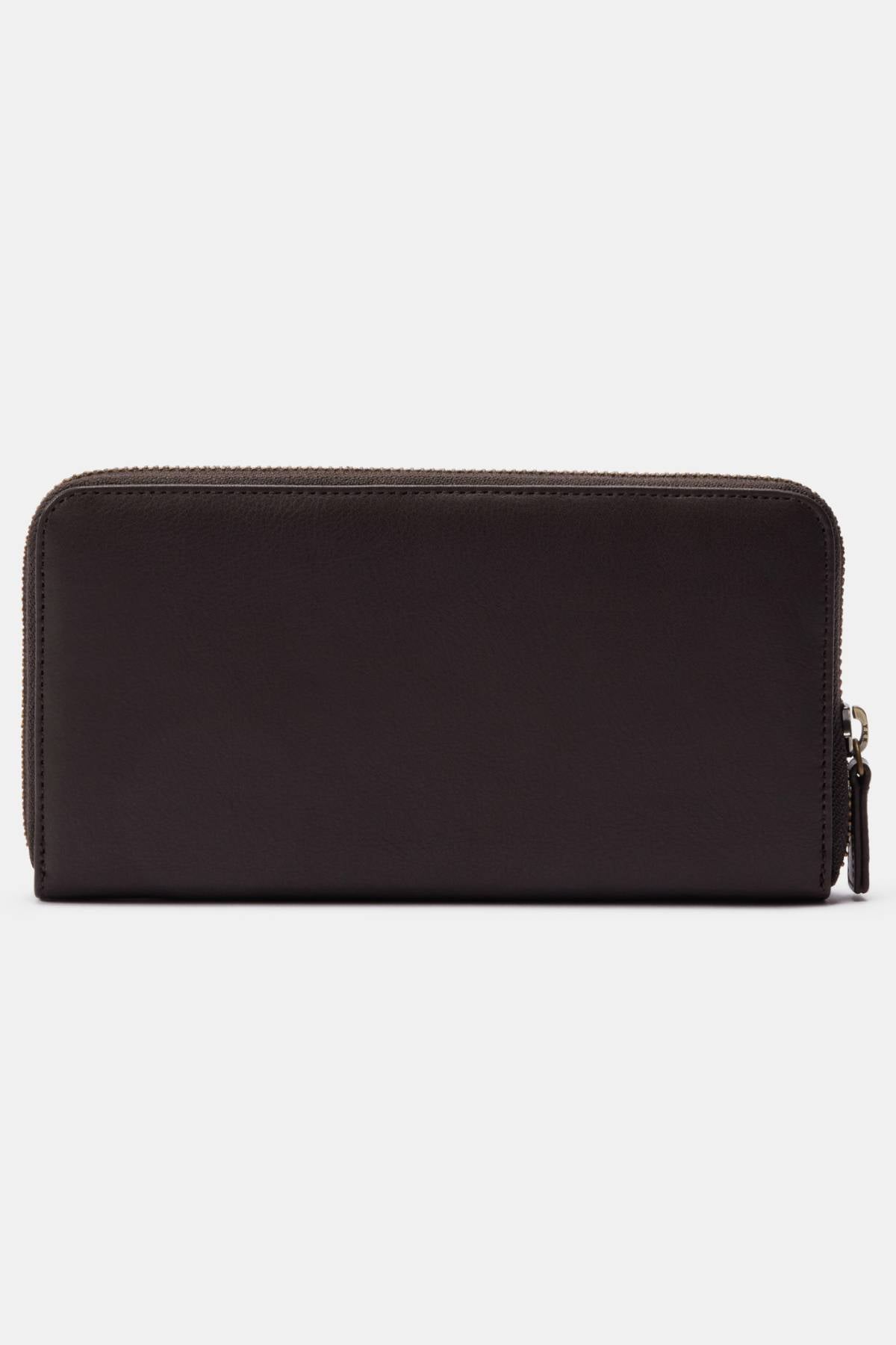 The RM Williams Singleton Zip Wallet, made of dark brown full-grain leather, features a rectangular minimalist design. It has a zip closure along three sides and offers ample internal storage, shown here against a white background.