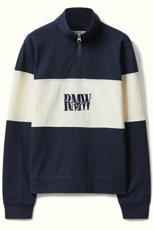 The RM Williams Trickett Panel Sweatshirt is a navy blue and cream long-sleeve quarter zip with a half-zip collar, bold cream chest stripe, and "RMW RLLW" printed in navy on the front center.