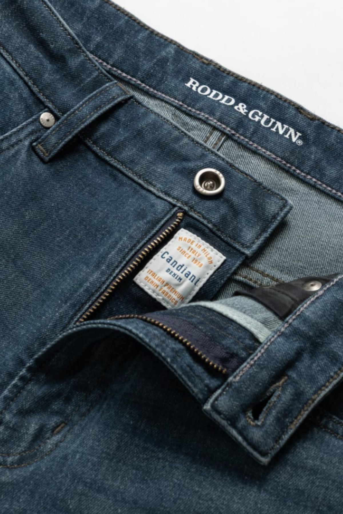 Close-up of blue Rodd & Gunn Kurow Relaxed Fit Italian Denim Jean, zipper and button undone to show inner labels, including “Candiani denim,” highlighting premium Italian craftsmanship.