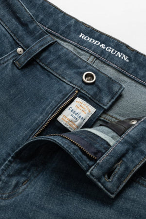 Close-up of blue Rodd & Gunn Kurow Relaxed Fit Italian Denim Jean, zipper and button undone to show inner labels, including “Candiani denim,” highlighting premium Italian craftsmanship.
