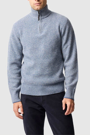 A man wears the Rodd & Gunn Robbies Road Knit pullover sweater with a half-zip collar and black pants, standing against a plain light gray background.
