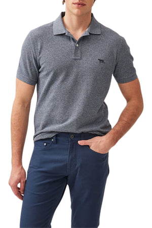 A man wears the Rodd & Gunn The Gunn Polo in gray, featuring a modern fit and short sleeves, made from Australian cotton, paired with dark blue pants. He stands against a white background with one hand in his pocket.