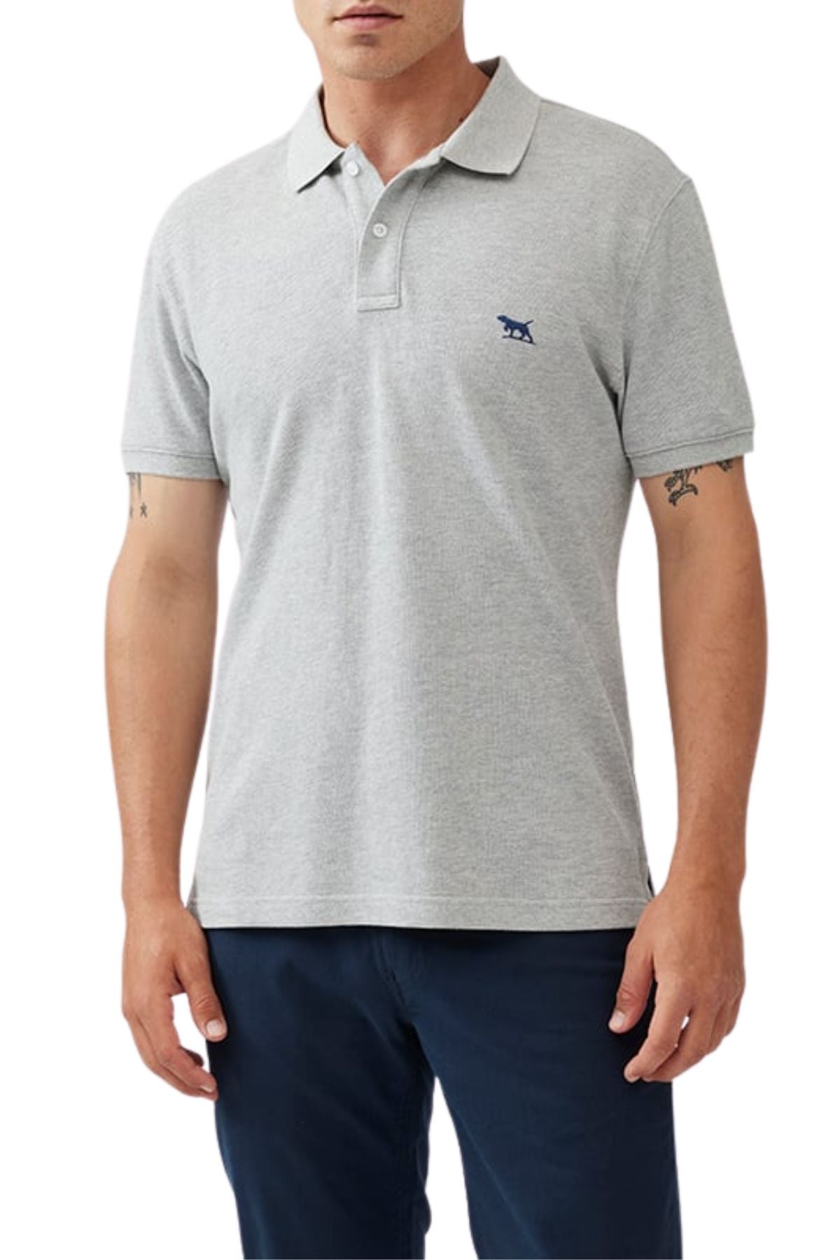A man wearing the Rodd & Gunn The Gunn Polo in light gray Australian cotton with a small navy animal logo on the chest and paired with dark navy pants, shown from the waist up.